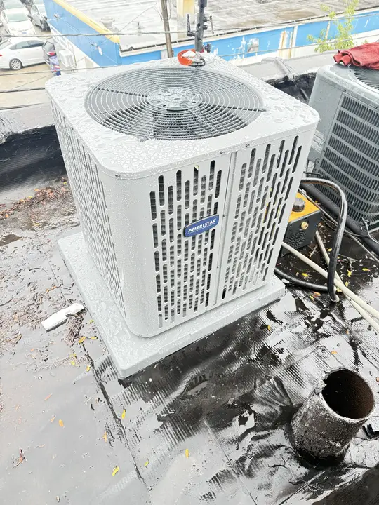 New Ameristar air conditioner condenser installed on a flat roof