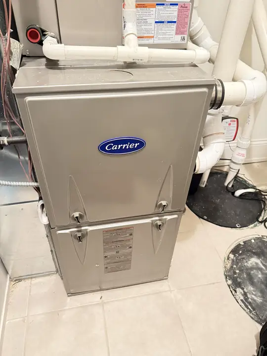 Carrier gas furnace with an indoor coil and condensate piping installed in a utility room
