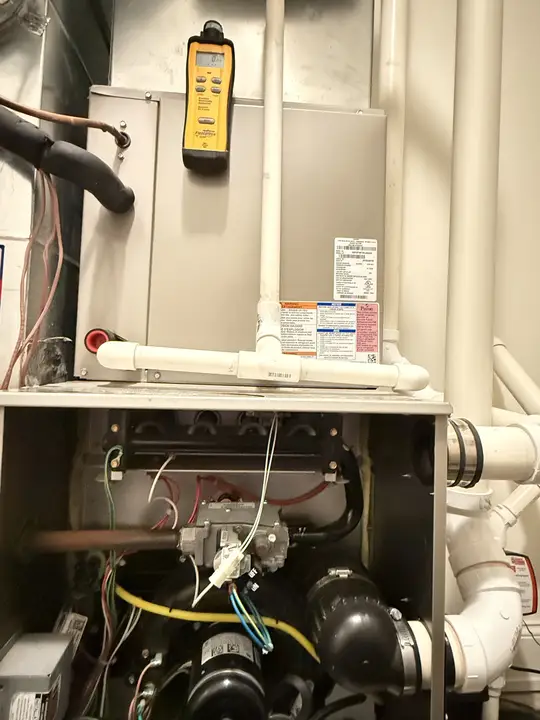 Combustion safety test on a gas furnace with a carbon monoxide detector reading 0 ppm