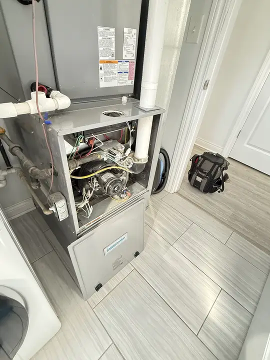 Comfortmaker gas furnace with the burner compartment open during service