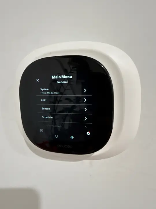 Ecobee smart thermostat showing the main menu with the HVAC mode set to heat
