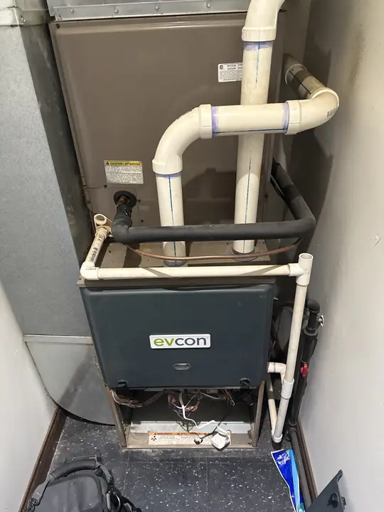 Evcon furnace with coil and PVC venting installed in a closet