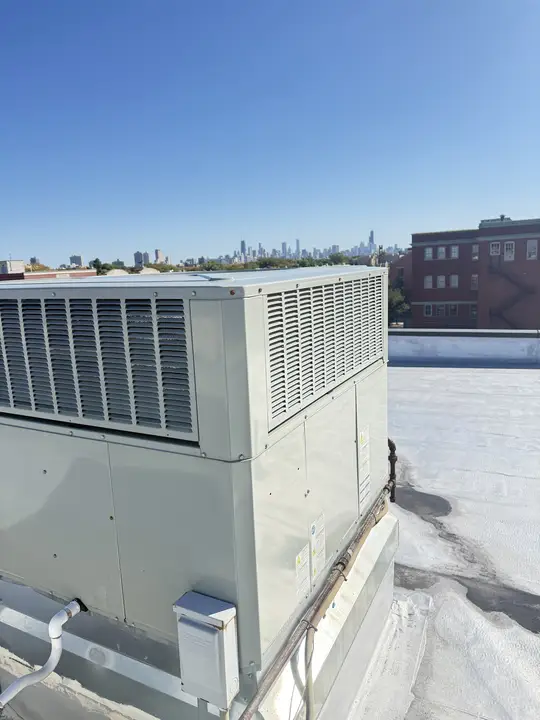 Rooftop packaged HVAC unit with the Chicago skyline in the background